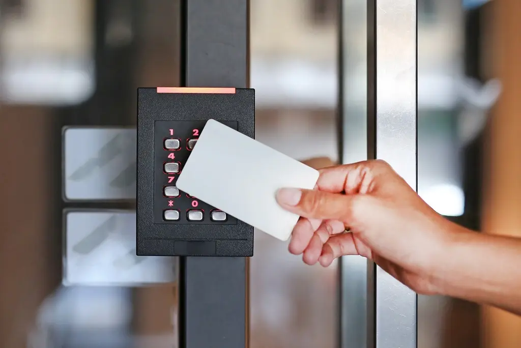 An access control card being swiped at a reader installed by Commercial Fire & Security.